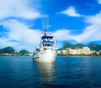 Fishing boat Marilia A anchored off Rio de Janeiro with a scenic cityscape backdrop.