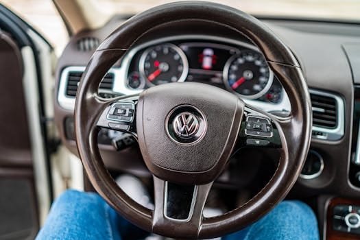 Interior view of a Volkswagen car, focusing on the steering wheel and dashboard.