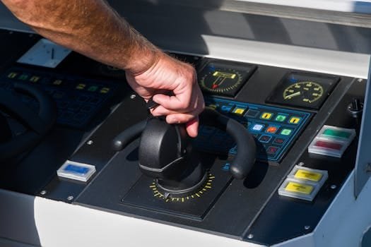 Cum să Alegi Cursul Certificat GMDSS București pentru Ofițeri Avansați 2 A close-up view of a hand managing a boat's control panel, emphasizing precision and control.