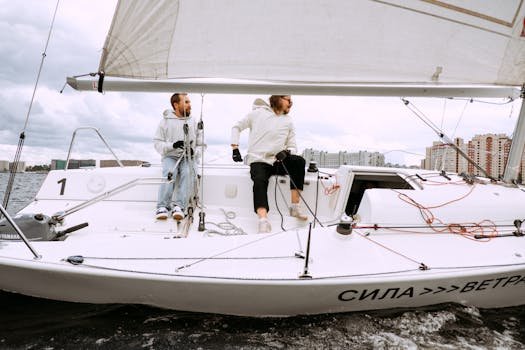 Two men yachting on a sailboat, capturing the excitement of sailing on open water.