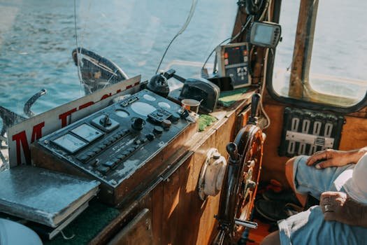 Detailed view of a vintage boat control room, showcasing equipment and a man's arm.