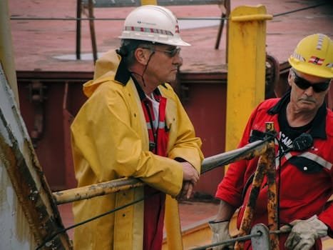 Men in safety gear managing ship operations on deck in Mackinaw City.