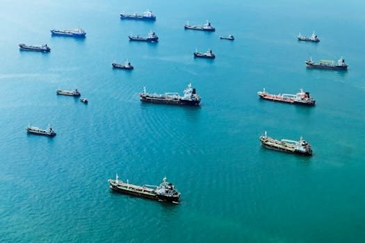 Analiza Beneficiilor Contractelor Internaționale pentru Marinari Români 4 Numerous cargo ships anchored on the blue ocean, captured from above.