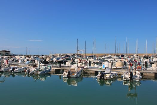 Top 5 Oportunități de Joburi în Catering la Bordul Navelor pentru August 2026 4 Boats docked in a serene marina in Montenero di Bisaccia, Italy, under clear blue skies.